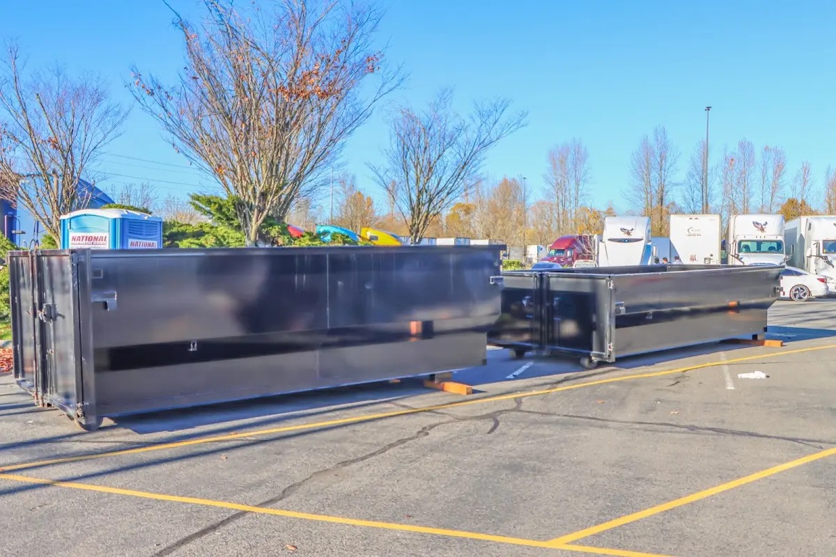Professional dumpster rental service with roll-off container on residential driveway in St. Augustine Beach